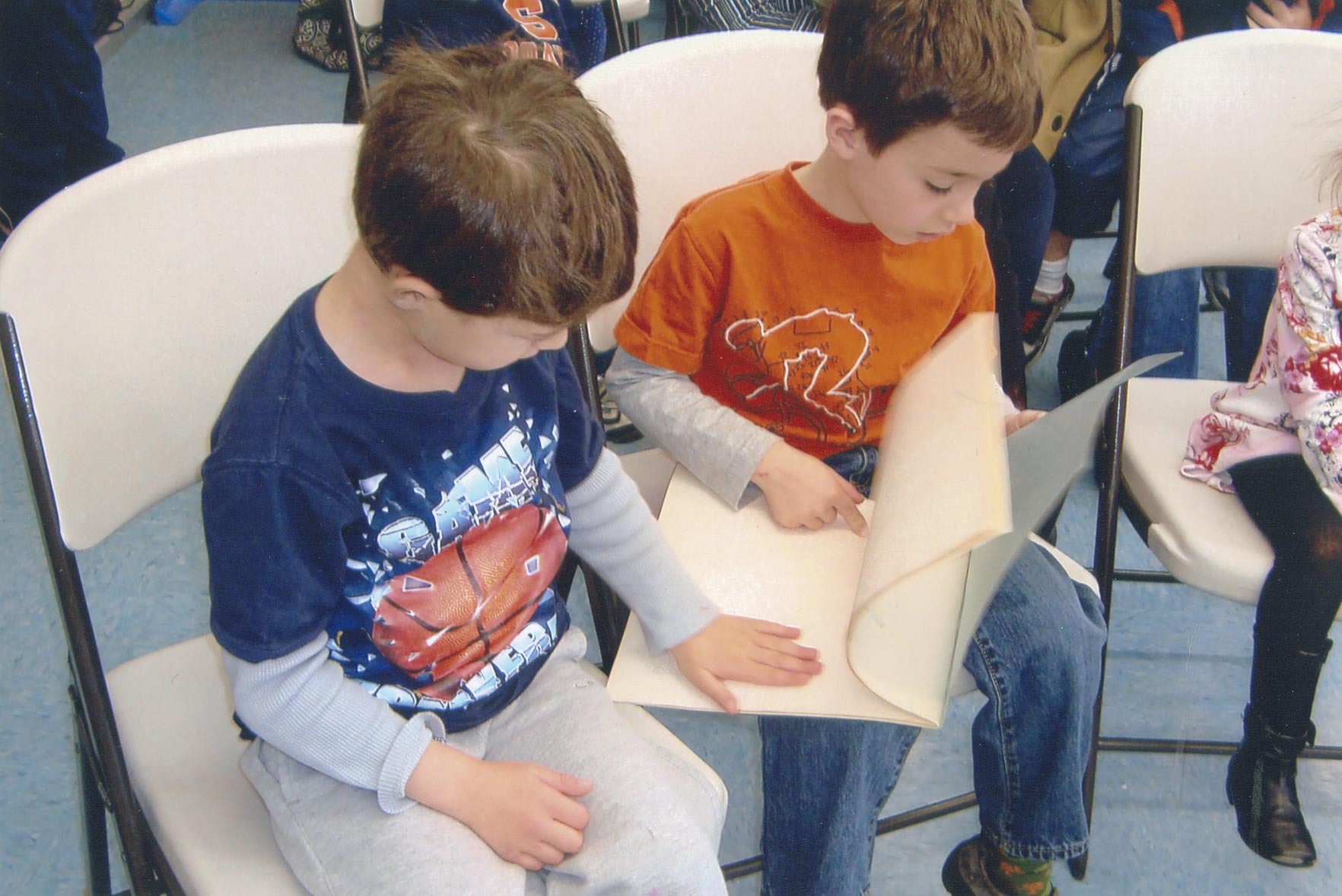 Image: A pair of schoolchildren reading from a Braille book